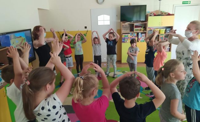 Zabawa ruchowa, przedszkolaki naśladują ruchy prowadzącej zajęcia