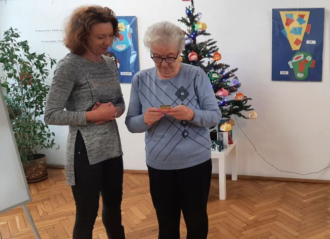 Uczestniczka warsztatów i prowadząca ustalają hasło do odgadnięcia z kart do gry.