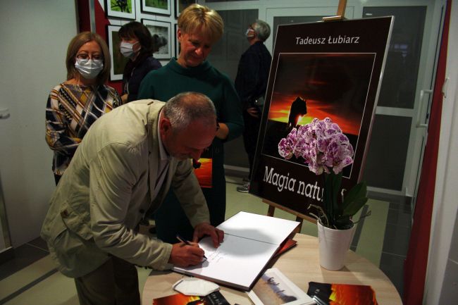 otografia przedstawia autora wystawy Pana Tadeusza Łubiarza i Panią dr Dorotę Mach - dyrektor Biblioteki Pedagogicznej w Zamościu oraz uczestniczkę wystawy, autor wystawy podpisuje album z fotografiami 