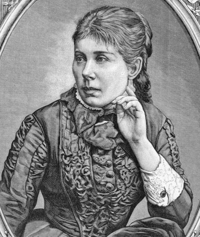 Zdjęcie przedstawia portret Marii Konopnickiej w formie drzeworytu Aleksandra Regulskiego według rysunku Józefa Buchbindera (1883). Konopnicka siedzi, jest zwrócona w swoją prawą stronę, lewą ręką dotyka swojego policzka, jest ubrana w suknię, włosy ma upięte w kok.