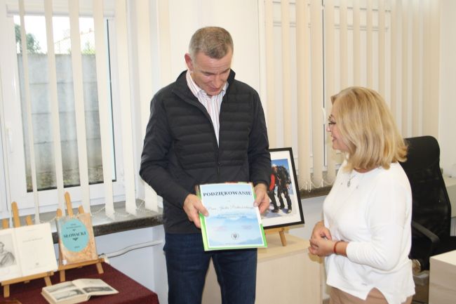 Wicedyrektor Biblioteki Pedagogicznej Anetta Sienkiewicz wręcza Jackowi Podkościelnemu podziękowanie za spotkanie w bibliotece.
